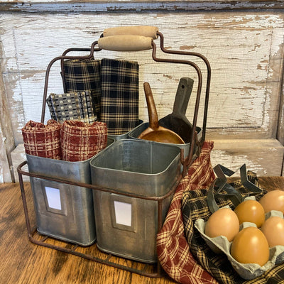 Metal caddy with plaid towels, a wooden spoon, and eggs on a rustic wooden surface.