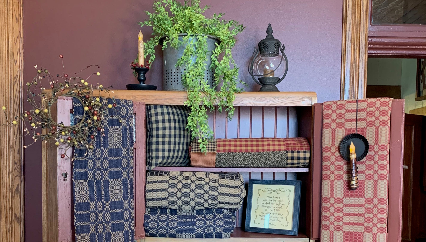 Hutch with greenery, runners and candles. 